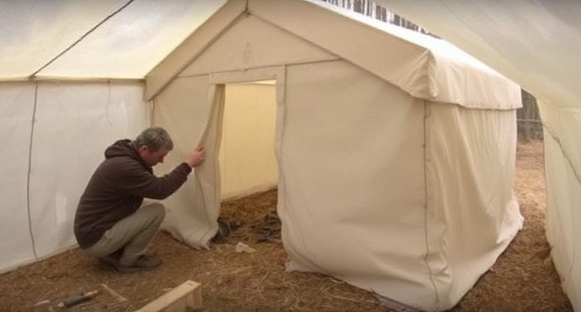 Survivalist Adding Insulation to Emergency Shelter